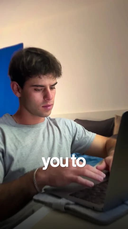 A creator sitting on a sofa with a laptop